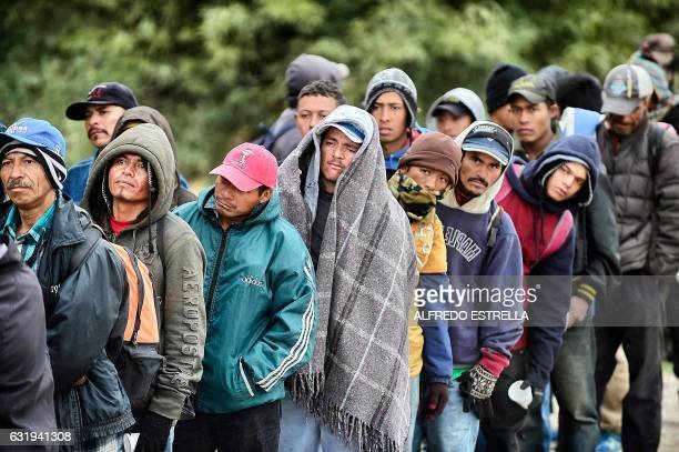 TOPSHOT - Migrants wait to receive food donated by people from the Community Center for Migrant Assistance in the community of Caborca in Sonora state, Mexico, on January 13, 2017. - Hundreds of Central American and Mexican migrants attempt to cross the US border daily. (Photo by ALFREDO ESTRELLA / AFP) (Photo by ALFREDO ESTRELLA/AFP via Getty Images)